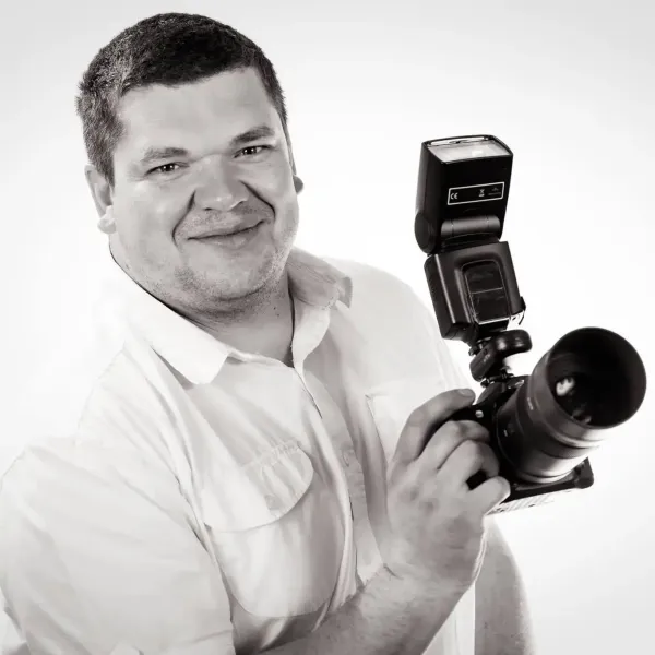 Pavel holding his camera and flash